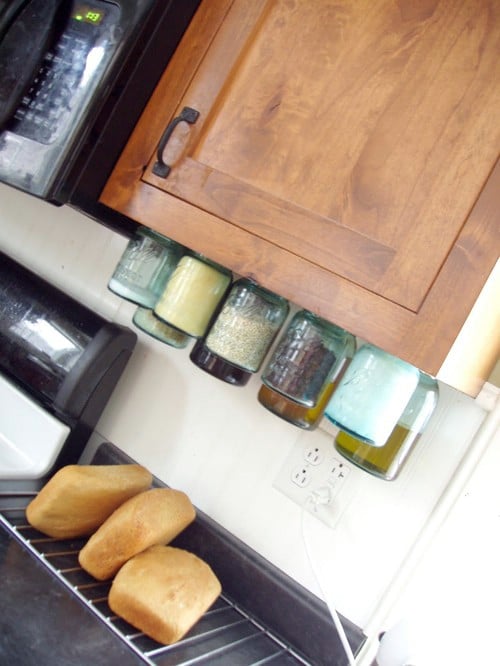 Mason Jars Hung from Cabinets - 150 Dollar Store Organizing Ideas and Projects for the Entire Home