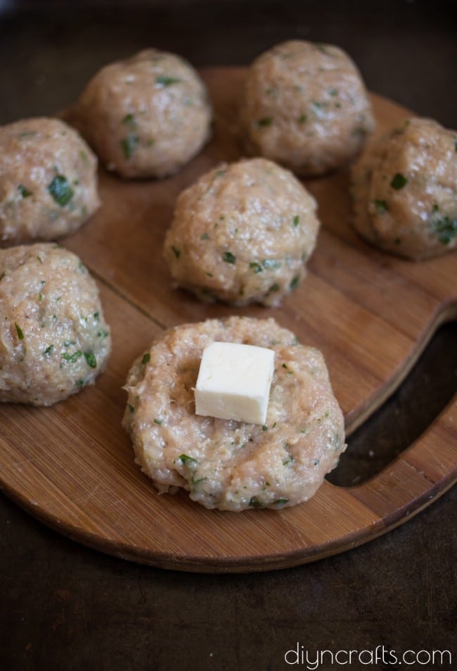 Adding the mozzarella into the meatballs.